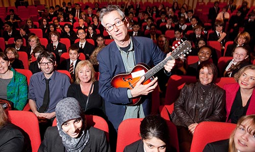 John Hegley performing in the Cosmo Rodewald Concert Hall for school groups