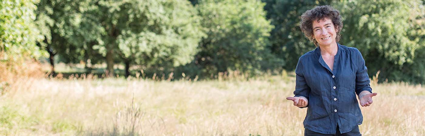 Jeanette Winterson standing in a field