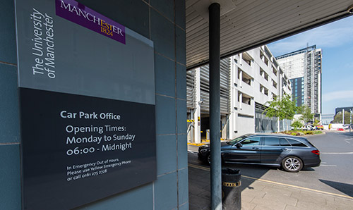 Opening hours sign by the Booth Street West multi-storey carpark